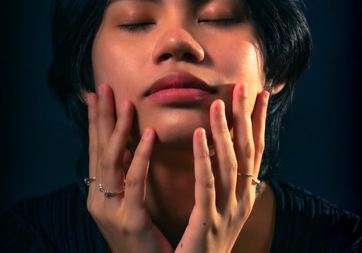 a woman with her hands on her face