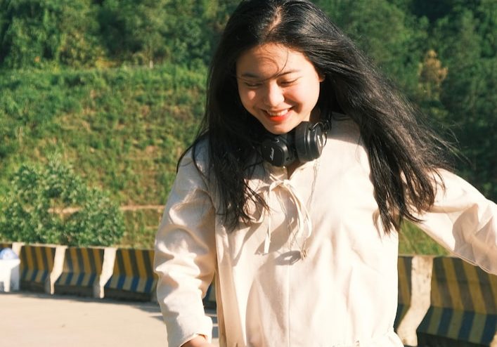 A woman in a white dress walking down a street